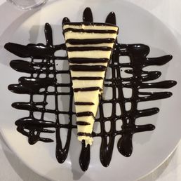 a slice of cheesecake with chocolate sauce