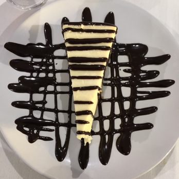 Just Off Main - a slice of cheesecake with chocolate sauce - Breakfast & Brunch Near Me - North Myrtle Beach, South Carolina