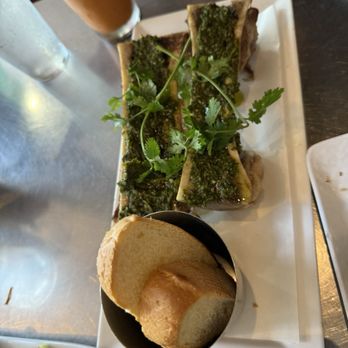Shank & Bone - Roasted bone marrow in cilantro chimichurri with bahn mi crostinis - Vietnamese Near Me - San Diego, California Shank & Bone - Roasted bone marrow in cilantro chimichurri with bahn mi crostinis - Vietnamese Near Me - San Diego, California