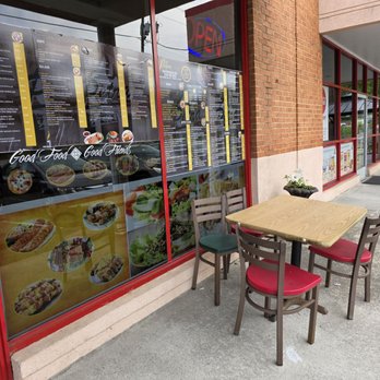 Petra Mediterranean Grill - The outdoor dining area with seating of two tables with four chairs each, one on each side of the front porch. - Mediterranean Near Me - Roanoke, Virginia Petra Mediterranean Grill - The outdoor dining area with seating of two tables with four chairs each, one on each side of the front porch. - Mediterranean Near Me - Roanoke, Virginia