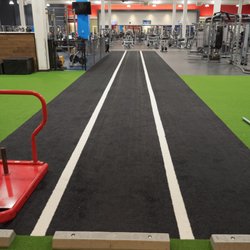 Genesis Health Clubs - East Harry - The turf area at our East Harry location provides you with lots of equipment to stretch and workout. Ready to test the sled push?
