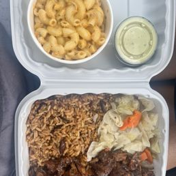 Regular size shack jerk chicken bowl, cabbage & carrots, coconut rice & beans with a side of macaroni and cheese, and Avocado crema. Regular size shack jerk chicken bowl, cabbage & carrots, coconut rice & beans with a side of macaroni and cheese, and Avocado crema.