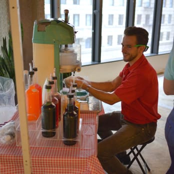 Breezy Freeze Snowball Co. - a man making a drink - Shaved Ice Near Me