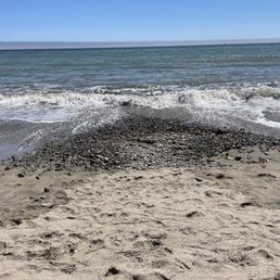 Beach has piles of rocks Beach has piles of rocks