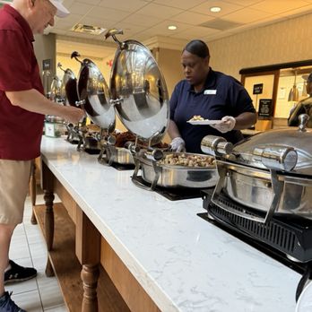 Embassy Suites by Hilton Williamsburg - Having staff serve the buffet items speeds the process...well done, ladies! - Hotels Near Me - Williamsburg, Virginia Embassy Suites by Hilton Williamsburg - Having staff serve the buffet items speeds the process...well done, ladies! - Hotels Near Me - Williamsburg, Virginia