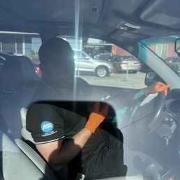 Pit stop worker is on his phone while driving customer vehicle Pit stop worker is on his phone while driving customer vehicle