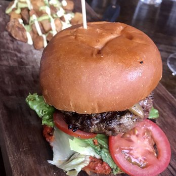 Solterra Winery & Kitchen - Lamb burger cooked medium rare with goat cheese, romesco, lettuce and tomato served with patatas bravas. - Wine Bars Near Me - Encinitas, California