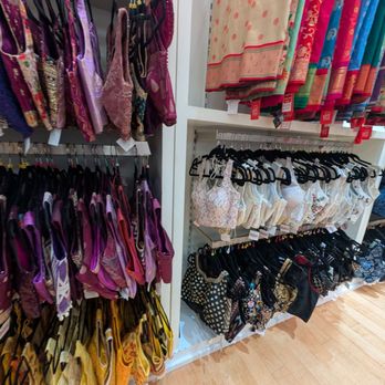 Mohini - Ready-Made blouses - A retail store shelf showcases a variety of bras in purple, pink, and yellow, along with scarves in different colors and patterns. - Women's Clothing Near Me - Dulles, Virginia