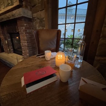 The Farm Table - a candle and a book on the table - New American Near Me - Bernardston, Massachusetts