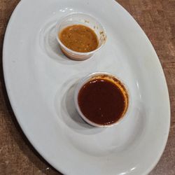 Dos Sisters - Housemade Hotsauce. The top came with my Ene's Chicken and it tates good with above medium heat. Bottom came with Burrito with Low Heat.