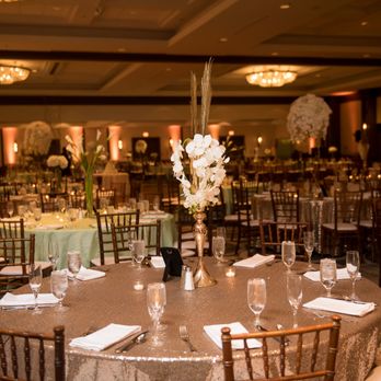 Elegance Decor - Elegance Decor created the perfect long and skinny centerpieces, which paired great with the shimmer and mint green tablecloths - Wedding Planning Near Me - Elk Grove Village, Illinois