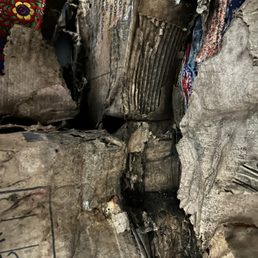 Peeking down a tunnel of rotten, soaking wet boxes