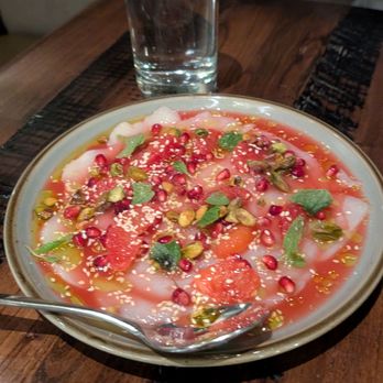 Tupelo Park City - Sliced Maine diver scallop crudo, blood orange juice, mint, pomegranate, chives, nuts and seeds ($21) - New American Near Me - Park City, Utah