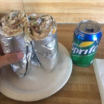 Taqueria Chavinda - a person holding a plate with a burrito - Mexican Near Me - Richmond, California