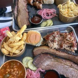 Brisket, pulled pork, jalapeño cheddar sausage. Sides are beans, fries, Mac and cheese, and potato salad. Brisket, pulled pork, jalapeño cheddar sausage. Sides are beans, fries, Mac and cheese, and potato salad.