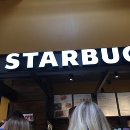 a starbucks sign above the entrance a starbucks sign above the entrance