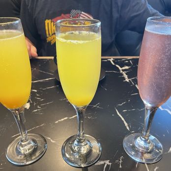 Le Gabrielle Crepes & Waffles - Monroe - Mango mimosa, regular oj mimosa and grapefruit mimosa (note a flight is full size glasses ‍) - Creperies Near Me - Monroe, Georgia