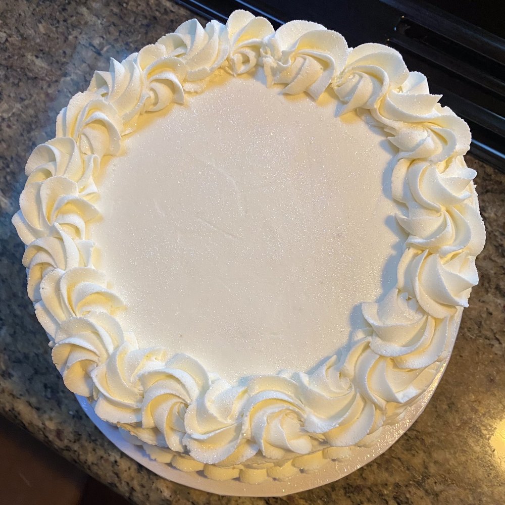 The Sugar Gallery - Top view: 8" coconut cake with pineapple filling and vanilla buttercream. - Custom Cakes Near Me The Sugar Gallery - Top view: 8" coconut cake with pineapple filling and vanilla buttercream. - Custom Cakes Near Me