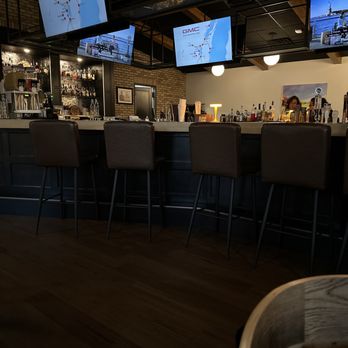 Lost Key Tap - a row of bar stools in front of televisions - Beer, Wine & Spirits Near Me - Wrightstown, Wisconsin