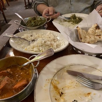 Cafe Spice - Chicken Tikka Masala, rice, Lamb Saag, and naan bread, already half eaten. - Indian Near Me - Cockeysville, Maryland Cafe Spice - Chicken Tikka Masala, rice, Lamb Saag, and naan bread, already half eaten. - Indian Near Me - Cockeysville, Maryland
