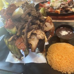 Tequila House NJ - Personal Molcajete (chorizo, steak , chicken , pork and cactus) comes with yellow rice and black beans.