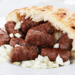 Sarajevo Grill & Meat - Cevapi. Grilled minced meat served with somun, a bosnian flatbread, and onions.