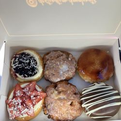 Destination Doughnuts - Blueberry cheesecake, fritter (strawberry and rhubarb), creme brûlée, strawberry cheesecake, fritter and chocolate overdose.