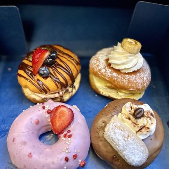 Donutique - My box of goodies! The Chocolate cream, banana cream, strawberry shortcake and tiramisu. - Coffee & Tea Near Me - Las Vegas, Nevada