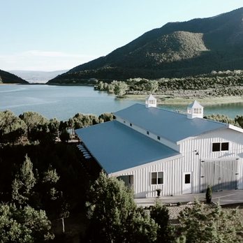 Vista View Events - Aerial shot of Vista View Events, a white wedding barn in Colorado. This photo shares the venue overlooking Harvey Gap Reservoir. - Venues & Event Spaces Near Me Vista View Events - Aerial shot of Vista View Events, a white wedding barn in Colorado. This photo shares the venue overlooking Harvey Gap Reservoir. - Venues & Event Spaces Near Me