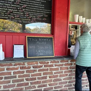 Dilly's at Centre Bridge - a woman looking at a menu - Ice Cream & Frozen Yogurt Near Me - New Hope, Pennsylvania Dilly's at Centre Bridge - a woman looking at a menu - Ice Cream & Frozen Yogurt Near Me - New Hope, Pennsylvania