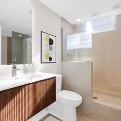 MK DESIGN & BUILD - New toilet installed, new vanity, new flooring, new mirror, new shower floor tiles, floating shelves added, and new shower head.