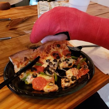Home Slice Pizza - a hand holding a slice of pizza - Pizza Near Me - Cairo, Georgia Home Slice Pizza - a hand holding a slice of pizza - Pizza Near Me - Cairo, Georgia