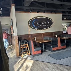 J R Cash's Grill & Bar - Entrance: booths and sign at front door