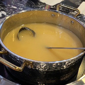 Chuan Chuan Bar - a pot of soup with tongs - Hot Pot Near Me - Toronto, Ontario