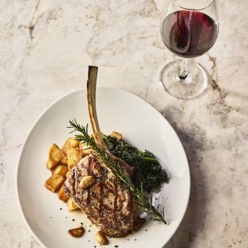 Amici Brentwood - Grilled Veal chop served with rosemary roasted potatoes - Italian Near Me - Santa Monica, California Amici Brentwood - Grilled Veal chop served with rosemary roasted potatoes - Italian Near Me - Santa Monica, California