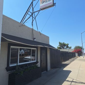 Alibi - Street view with adjacent private parking lot view west. - Pool Halls Near Me - Fresno, California