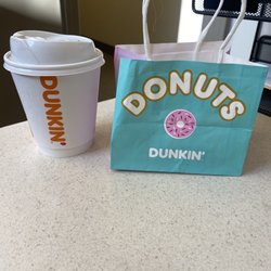 Dunkin Donuts - Midnight coffee with almond milk and a vanilla frosted sprinkle donut in a cute little bag.