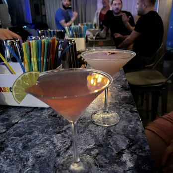 Infinity Lounge - two martinis on a bar with people in the background - Lounges Near Me - Wilton Manors, Florida