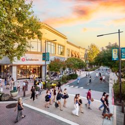 Broadway Plaza - Lululemon storefront at Broadway Plaza, with shoppers along the open-air shopping street at sunset.
