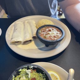Ground beef enchiladas with queso, pintos, rice, guacamole