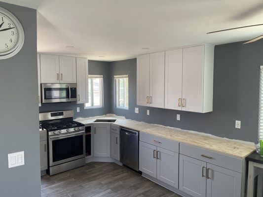 Kitchen Remodel - This was a out dated kitchen that was updated by installing all new cabinets,  opened up the dinning room wall to make it larger. installed new slab and paint.