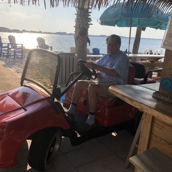 Sneaky Tiki Bar - Owner of the RV Park cruising around the bar literally - Tiki Bars Near Me - Pensacola Beach, Florida