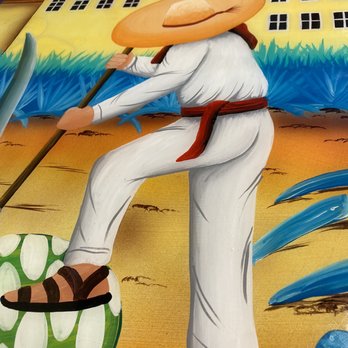 El Molcajetes - a man with a straw hat on a beach - Mexican Near Me - Palmetto, Florida El Molcajetes - a man with a straw hat on a beach - Mexican Near Me - Palmetto, Florida