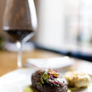 Bacchus Kitchen + Bar - a plate of food and a glass of wine - American Near Me - Grapevine, Texas