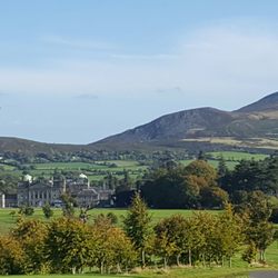 Powerscourt Golf Club - The original home with the rolling hills in the background, at the 18th tee.