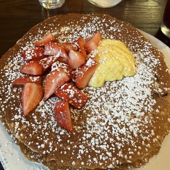 First Watch - This is a pancake with a lemon curd sauce and strawberries  very delicious it is large very filling - Breakfast & Brunch Near Me - Sarasota, Florida