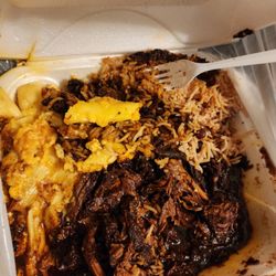Large Brown Stewed Chicken with Mac & cheese rice & peas.