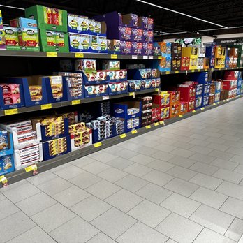ALDI - Grocery store aisle with shelves filled with boxed desserts, including cakes, cookies, and snack items, with price tags visible. - Grocery Near Me - Roseville, Michigan