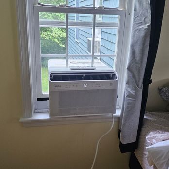 Pine Tree Handyman - This man is professional and quick. He did a great job. He charged a decent rate for putting in 2 window units. - A window air conditioner is installed in a bedroom window, with a digital display showing 72 degrees, and a cord hanging down. - Handyman Near Me - Orrington , Maine