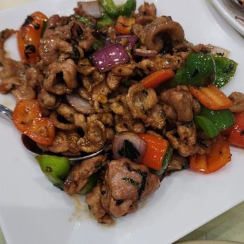 Zhen Restaurant - Stir fry pork knuckle - A dish of stir fry pork knuckle with mixed vegetables, including bell peppers and onions, served on a white square plate. - Chinese Near Me - Millbrae, California